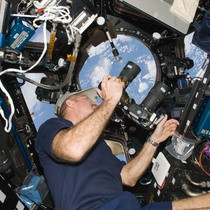 NASA Astronaut Dan Burbank hold one of the Full Spectrum cameras modified by Spencer's Camera & Photo.